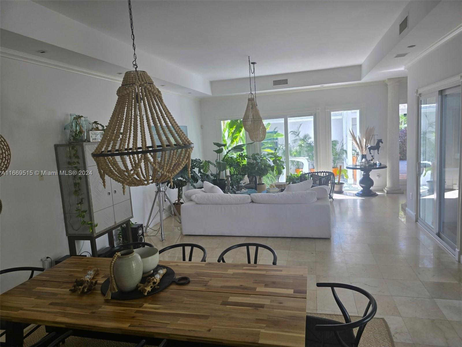 4 Turtle Walk, Unit 4 Key Biscayne, FL 33149 - Photo 12 of 29 a room with lots of potted plants
