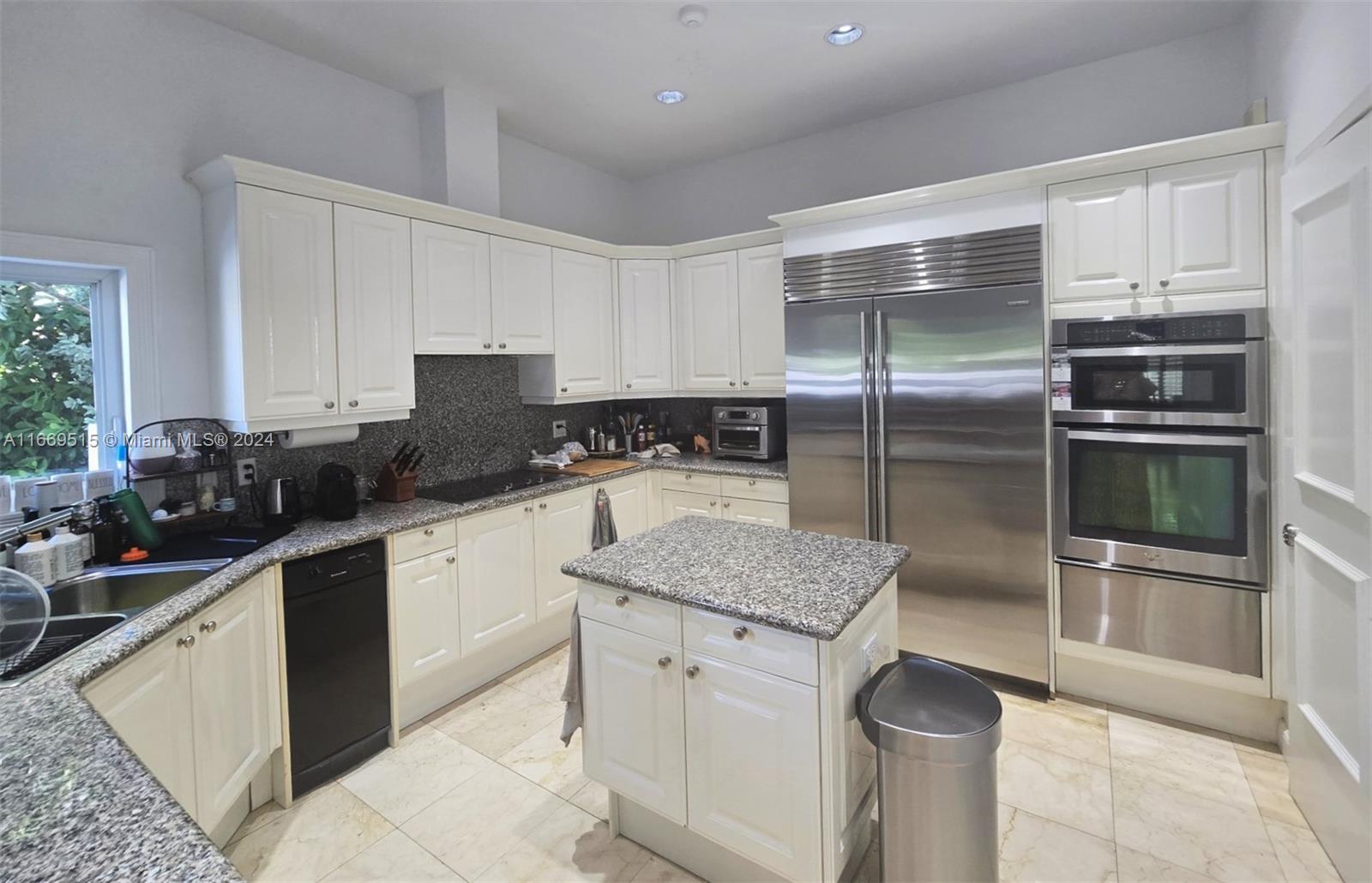 4 Turtle Walk, Unit 4 Key Biscayne, FL 33149 - Photo 17 of 29 a kitchen with a sink stove and refrigerator