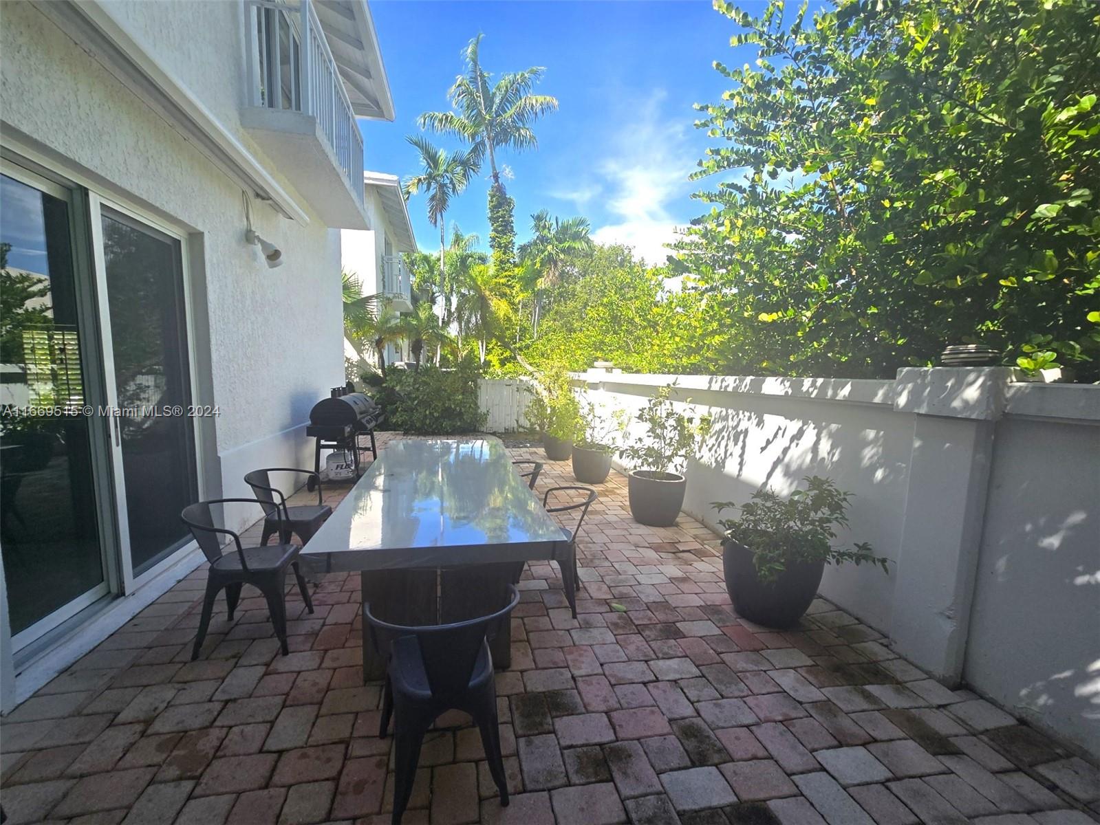 4 Turtle Walk, Unit 4 Key Biscayne, FL 33149 - Photo 18 of 29 a view of a dining room with furniture and a potted plant