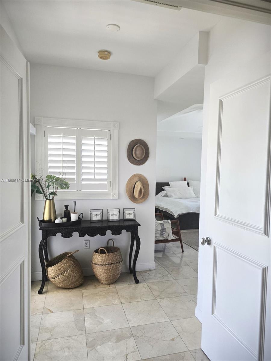 4 Turtle Walk, Unit 4 Key Biscayne, FL 33149 - Photo 21 of 29 a living room with furniture a clock and a window