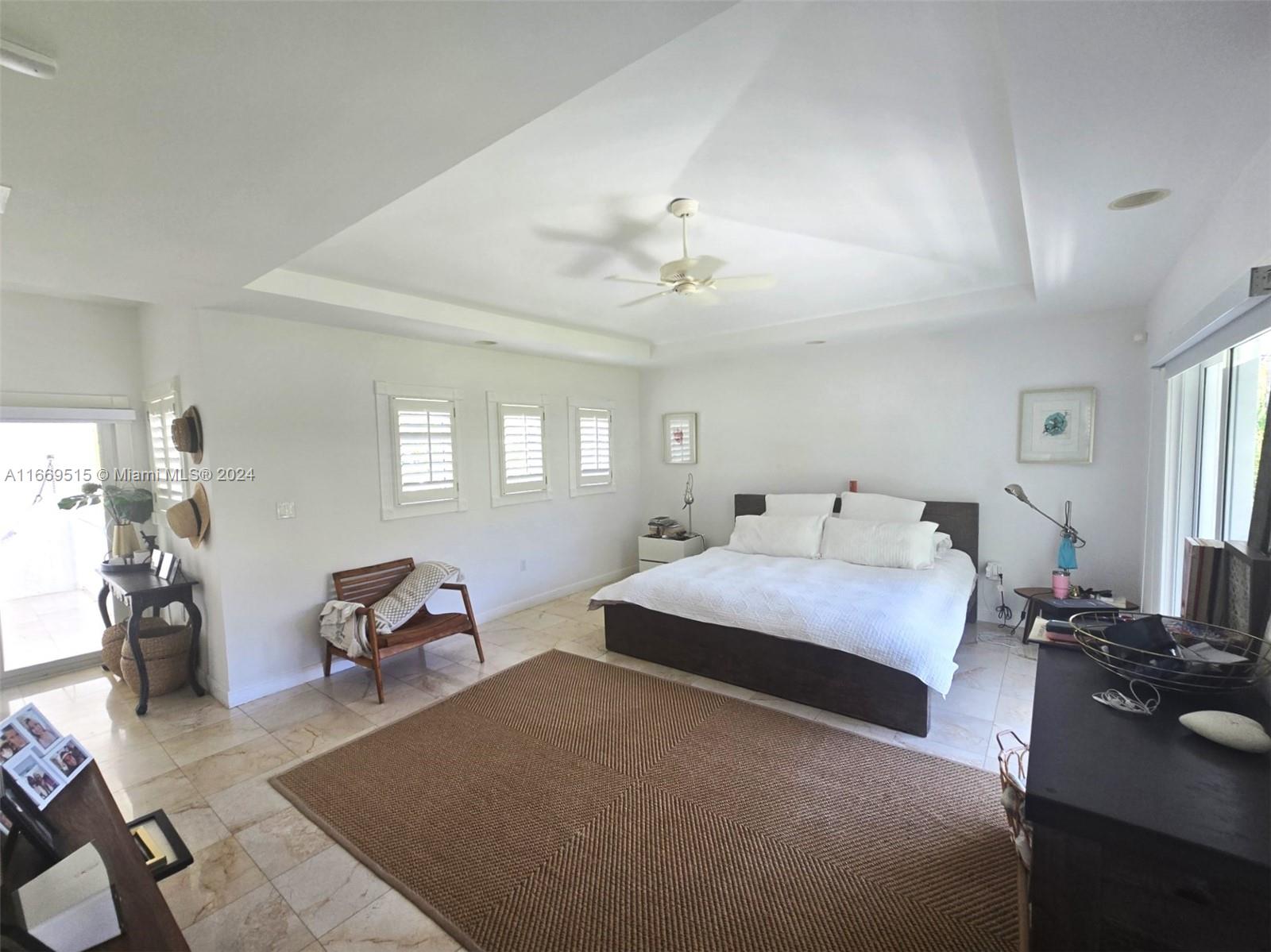 4 Turtle Walk, Unit 4 Key Biscayne, FL 33149 - Photo 22 of 29 a bedroom with a bed and wooden floor