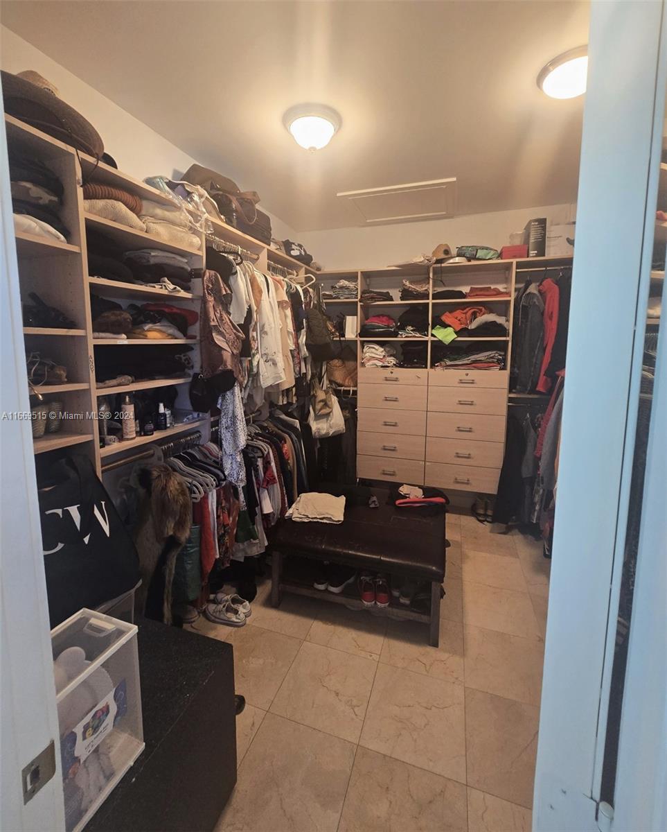 4 Turtle Walk, Unit 4 Key Biscayne, FL 33149 - Photo 23 of 29 a view of walk in closet with clothes and shoes