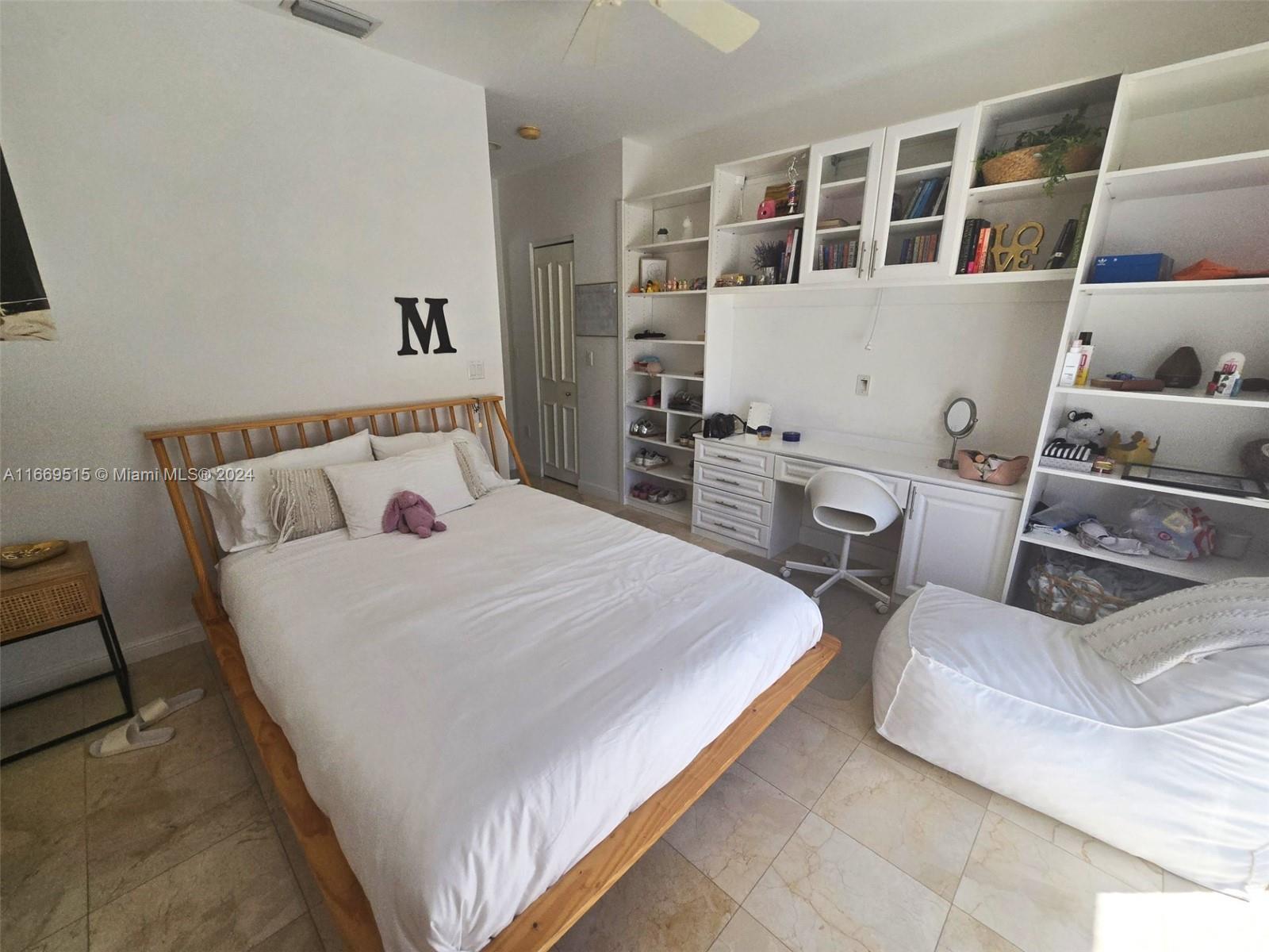 4 Turtle Walk, Unit 4 Key Biscayne, FL 33149 - Photo 25 of 29 a bedroom with a bed and wooden floor