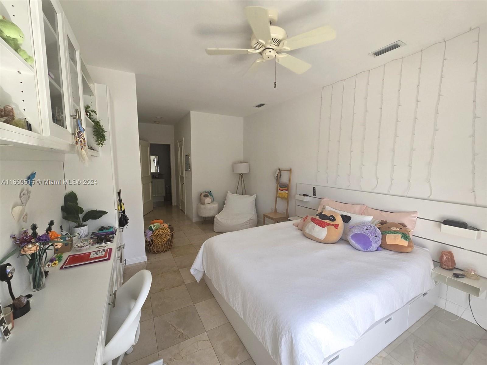 4 Turtle Walk, Unit 4 Key Biscayne, FL 33149 - Photo 26 of 29 a bedroom with a bed dresser and a window