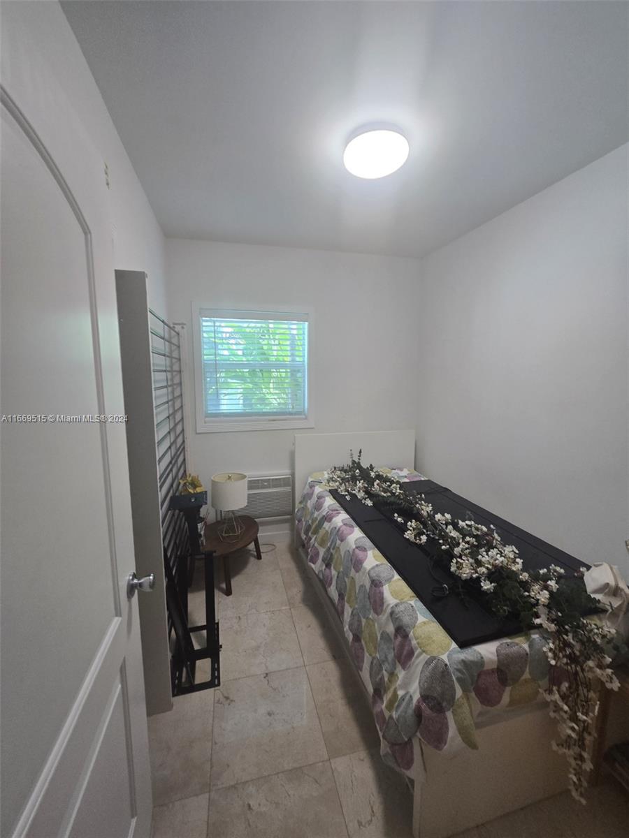 4 Turtle Walk, Unit 4 Key Biscayne, FL 33149 - Photo 27 of 29 a bedroom with a bed and a window