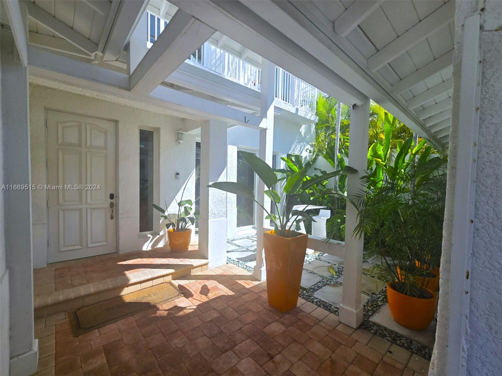 4 Turtle Walk, Unit 4 Key Biscayne, FL 33149 - Photo 3 of 29 a view of a porch with plants