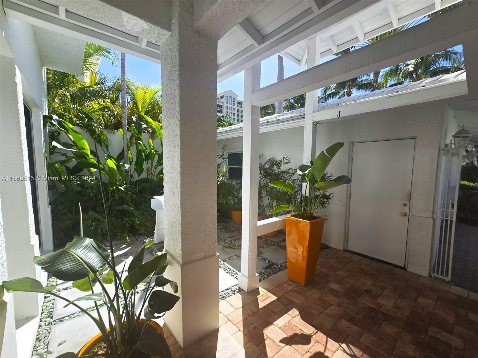 4 Turtle Walk, Unit 4 Key Biscayne, FL 33149 - Photo 4 of 29 a view of a vase of flowers sitting on a table