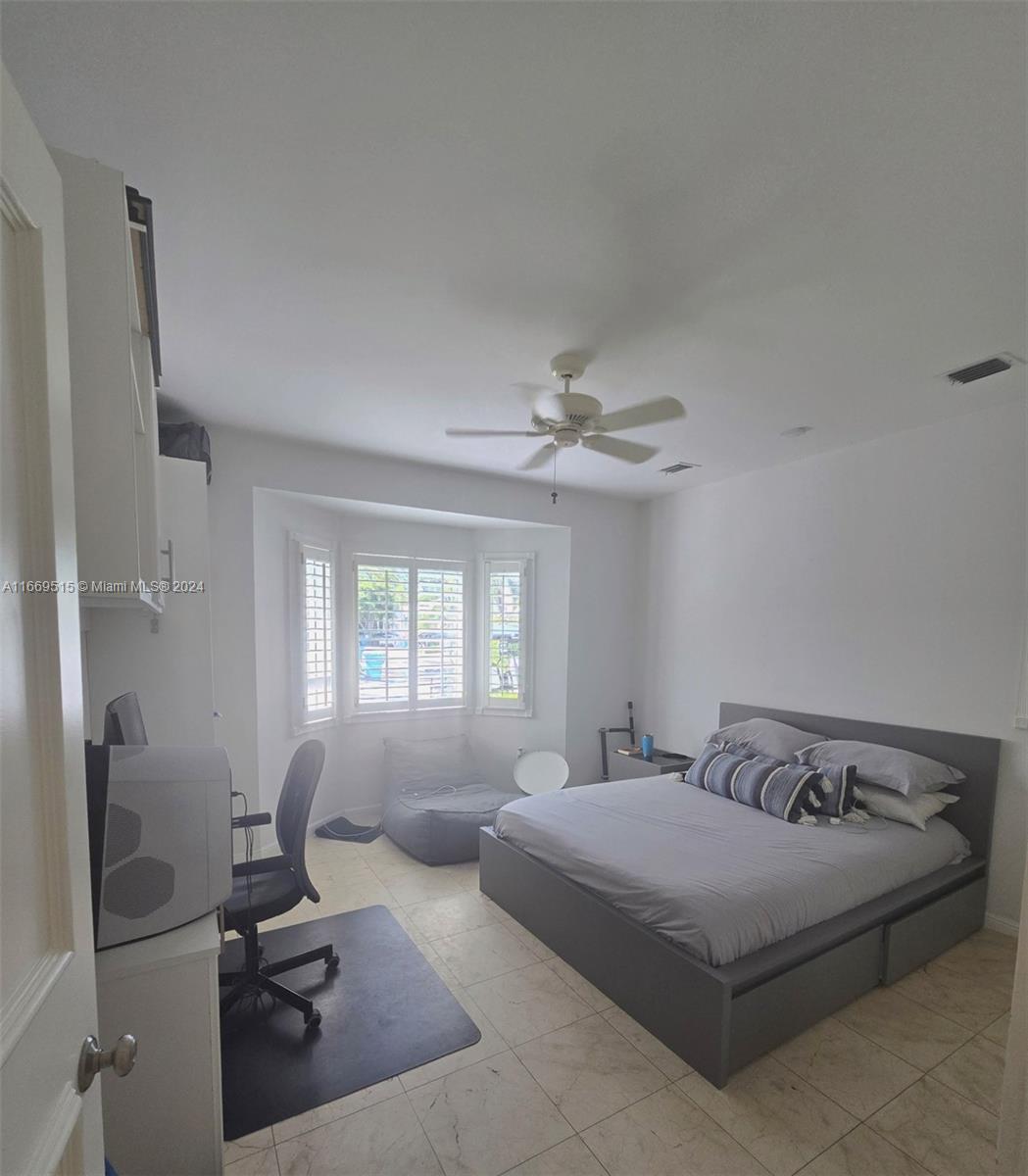 4 Turtle Walk, Unit 4 Key Biscayne, FL 33149 - Photo 6 of 29 a bedroom with a bed flat screen tv and window