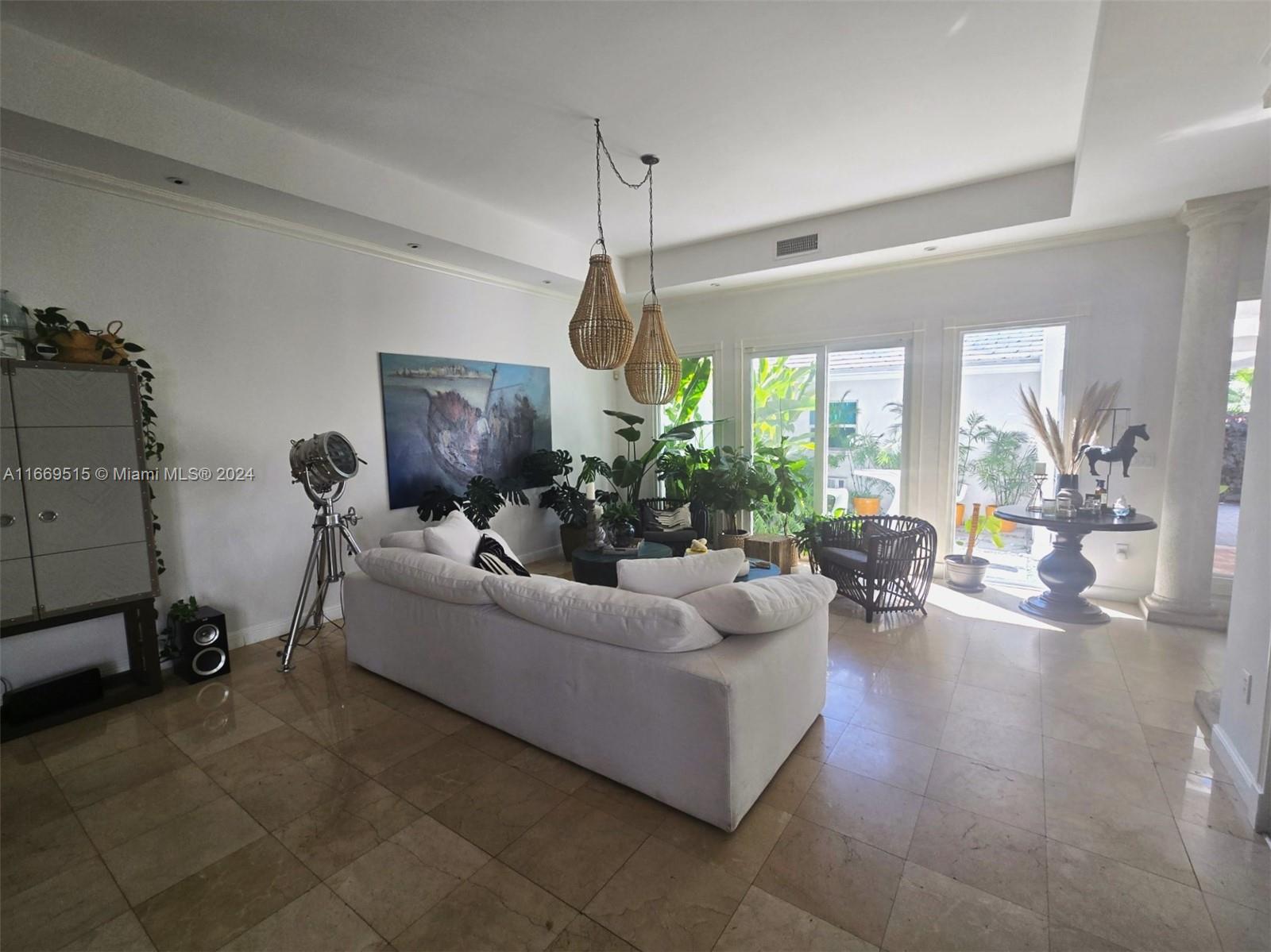 4 Turtle Walk, Unit 4 Key Biscayne, FL 33149 - Photo 10 of 29 a living room with furniture a window and gym equipment