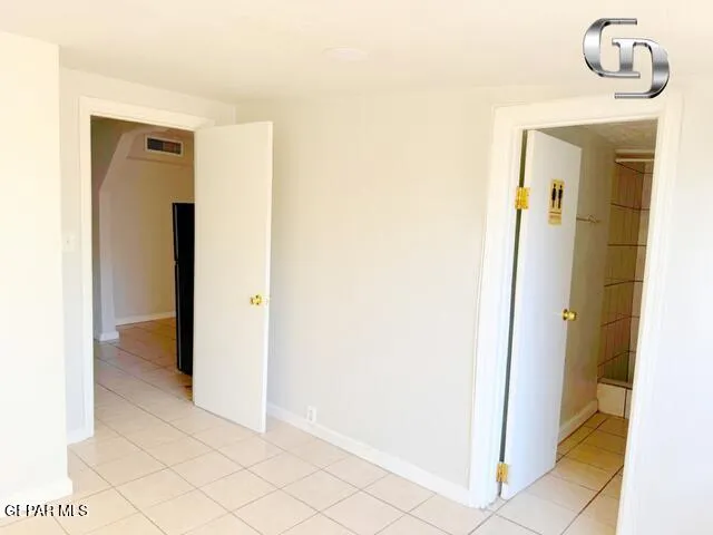 a view of a hallway to rooms