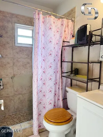a bathroom with a toilet and a shower