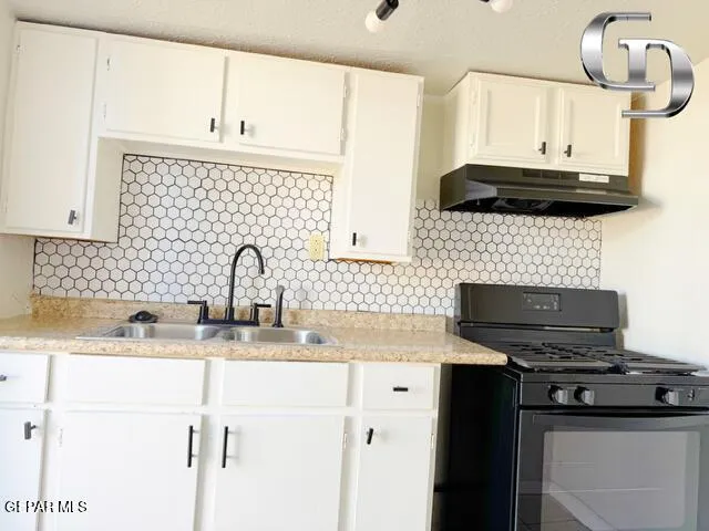 a kitchen with stainless steel appliances a sink stove and cabinets