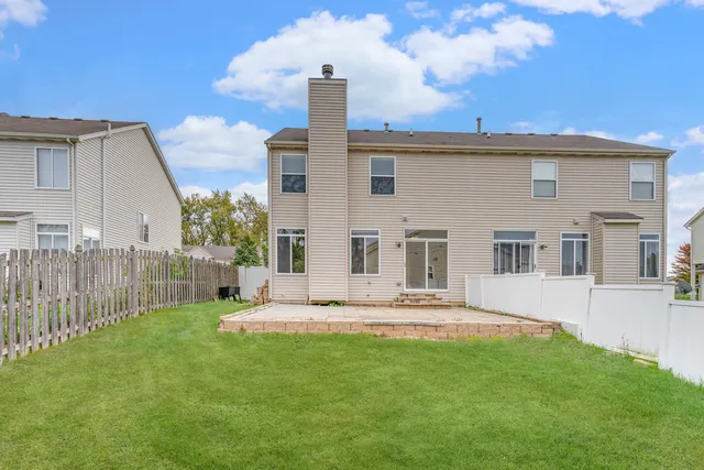 a front view of a house with a garden and plants