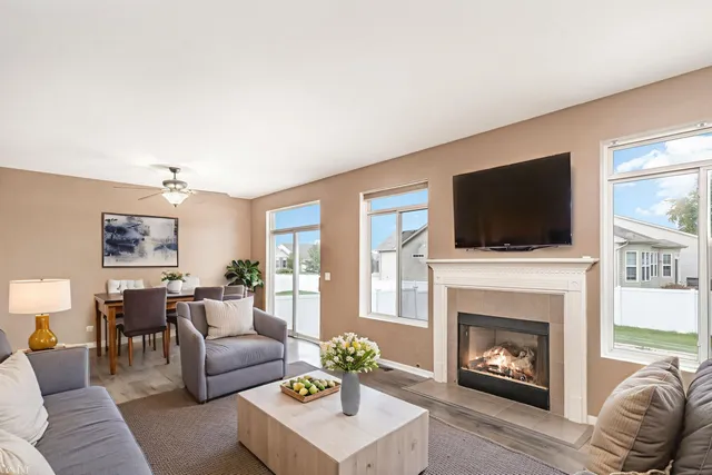 a living room with furniture a flat screen tv and a fireplace