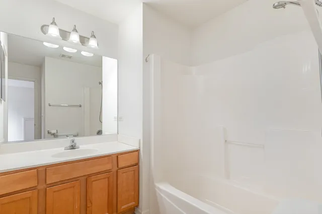 a bathroom with a bathtub a sink and a mirror
