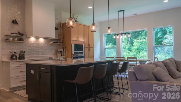 a kitchen with stainless steel appliances granite countertop a sink a stove and a refrigerator