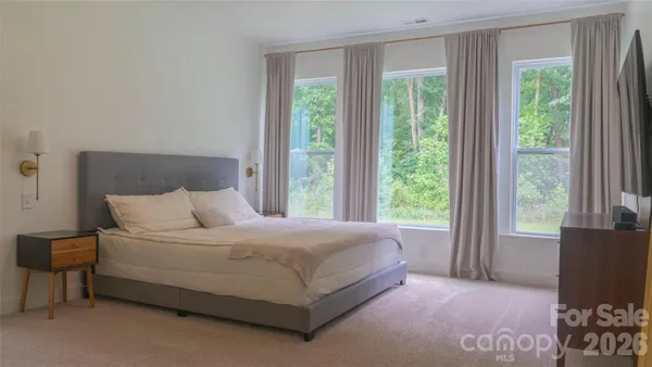 a bedroom with a bed and a large window