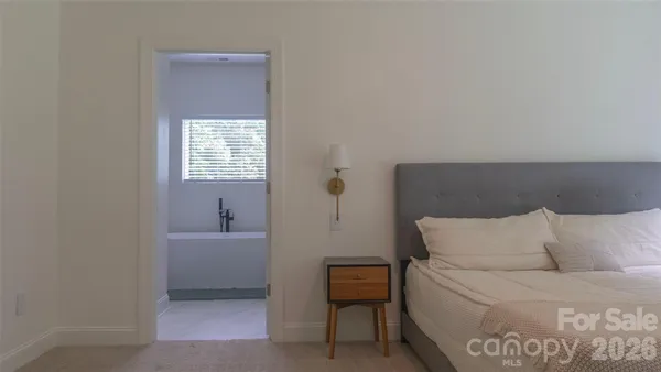 a bedroom with a bed and a chair