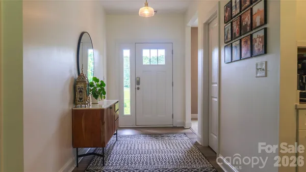 a view of a room that has a door and a rug