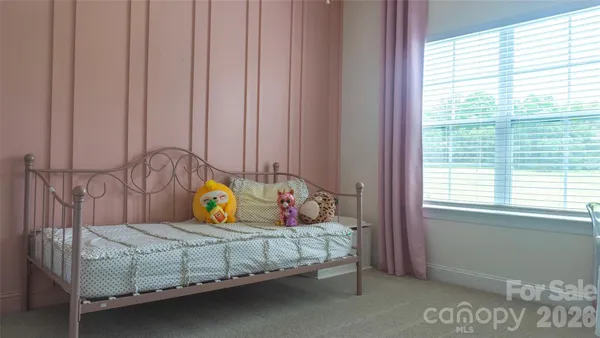 a bedroom with a bed a table and a window