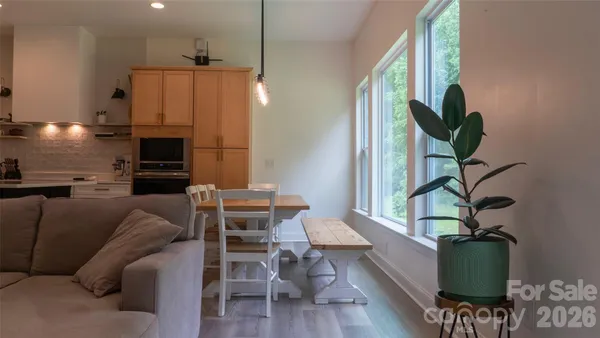 a living room with furniture a couch and a potted plant