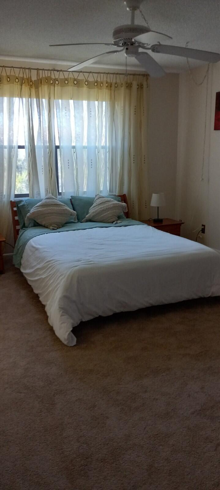 9355 Southwest 8th Street, Unit 402 Boca Raton, FL 33428 - Photo 5 of 5 a bedroom with a bed and a window