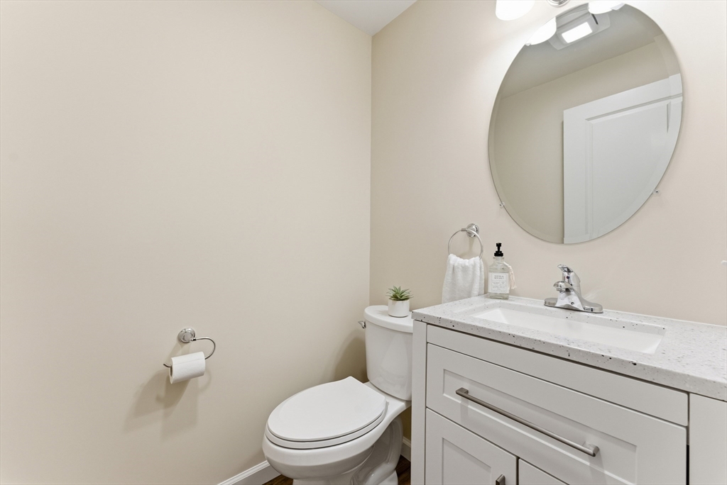 84 Fuller Street, Unit 1 Ludlow, MA 01056 - Photo 13 of 34 a bathroom with a toilet sink and mirror