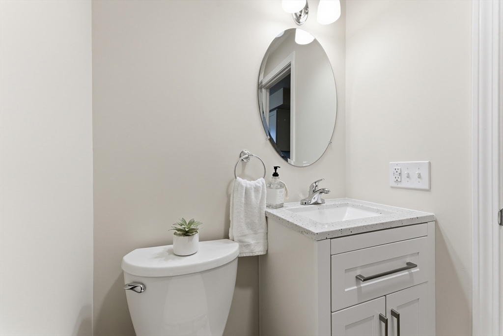 84 Fuller Street, Unit 1 Ludlow, MA 01056 - Photo 14 of 34 a bathroom with a sink toilet and a mirror
