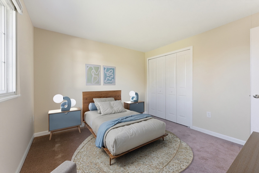 84 Fuller Street, Unit 1 Ludlow, MA 01056 - Photo 18 of 34 a bedroom with a bed and a painting on the wall