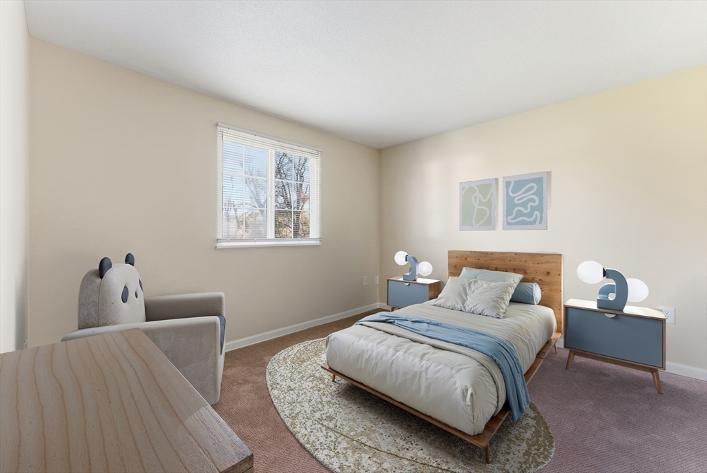 84 Fuller Street, Unit 1 Ludlow, MA 01056 - Photo 19 of 34 a bedroom with a bed and wooden floor