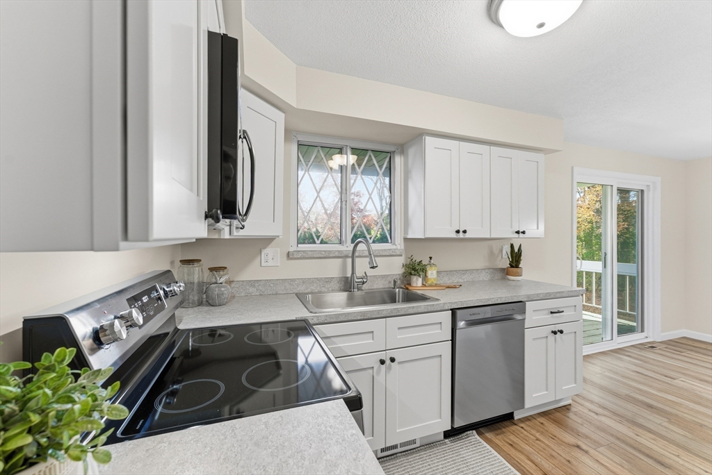 84 Fuller Street, Unit 1 Ludlow, MA 01056 - Photo 9 of 34 a kitchen with a sink stove and cabinets