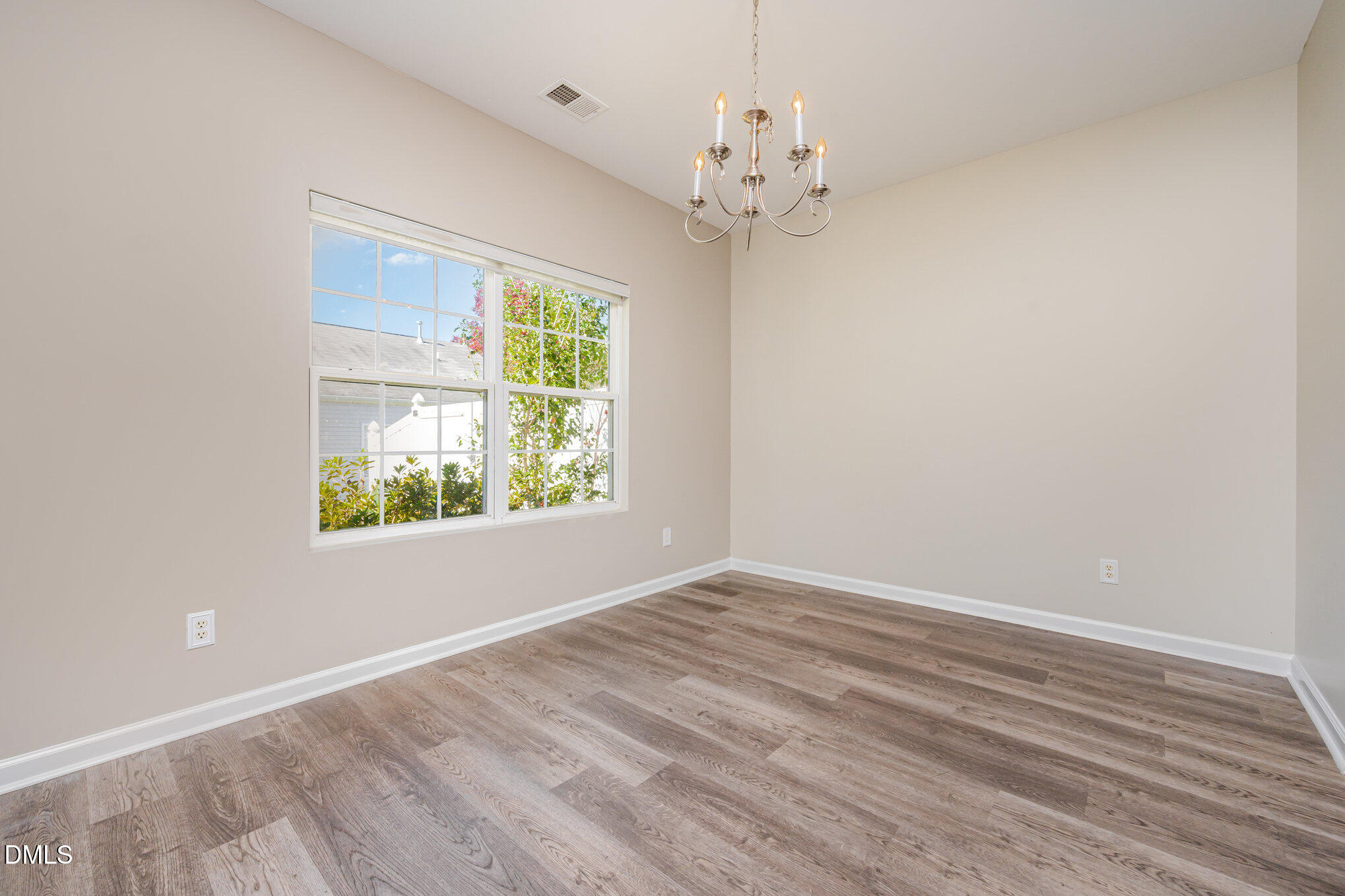 1508 Bancroft Court Graham, NC 27253 - Photo 5 of 33 a view of an empty room with wooden floor and a window