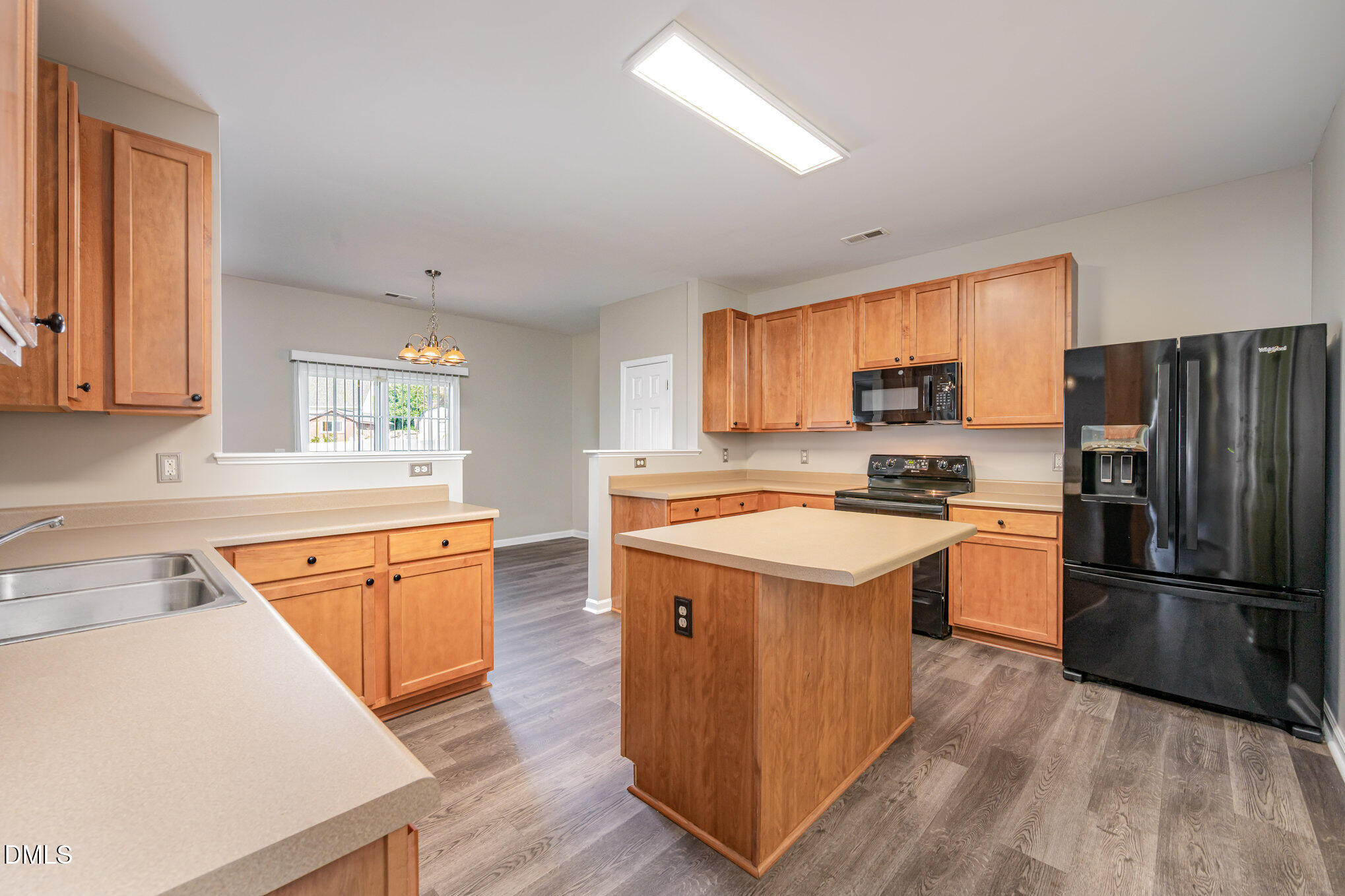 1508 Bancroft Court Graham, NC 27253 - Photo 8 of 33 a kitchen with wooden floors and stainless steel appliances