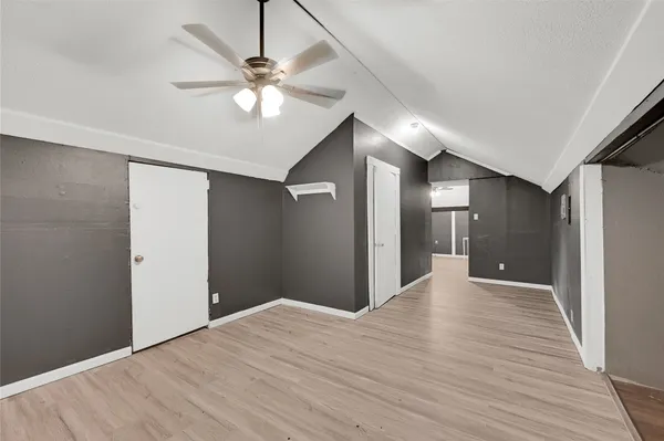 a view of a livingroom with a ceiling fan and wooden floor