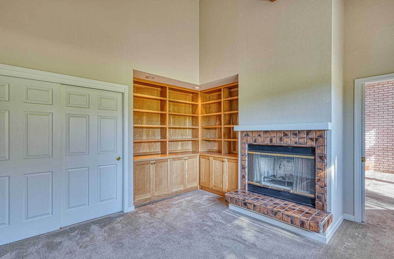 1056 Rodeo Road Pebble Beach, CA 93953 - Photo 14 of 17 a view of an empty room with a fireplace and a window