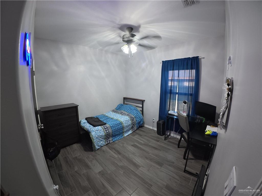 321 Gladiola Drive Edcouch, TX 78538 - Photo 14 of 29 a bedroom with a bed and a chandelier fan