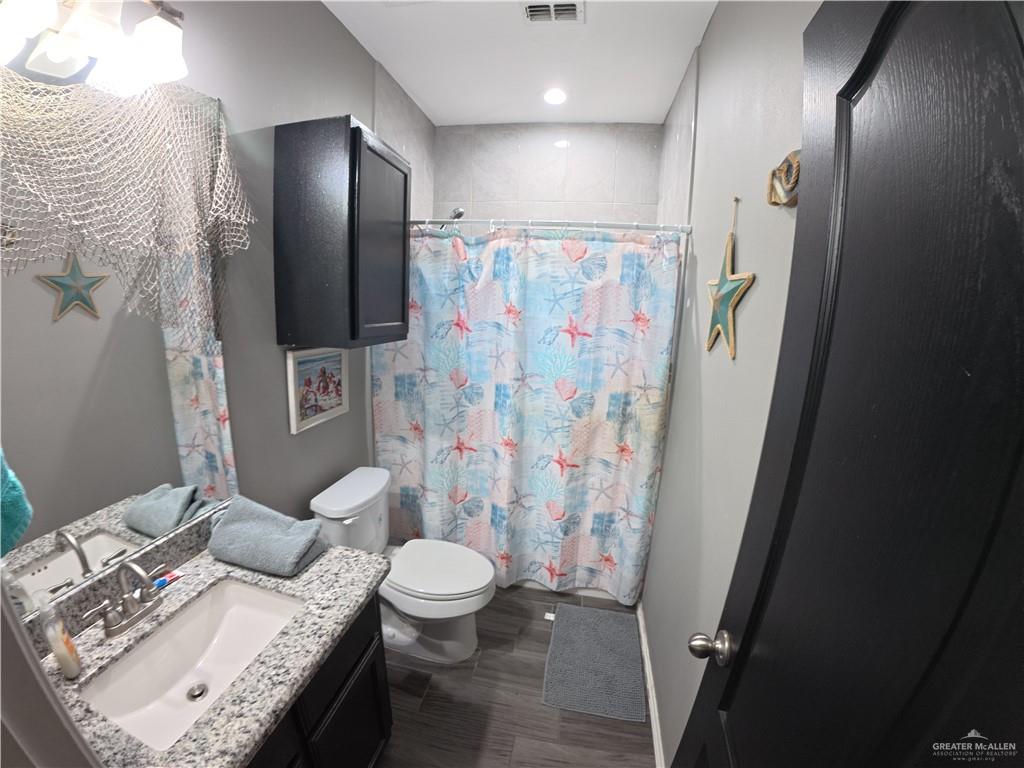 321 Gladiola Drive Edcouch, TX 78538 - Photo 9 of 29 a bathroom with a granite countertop sink toilet and shower