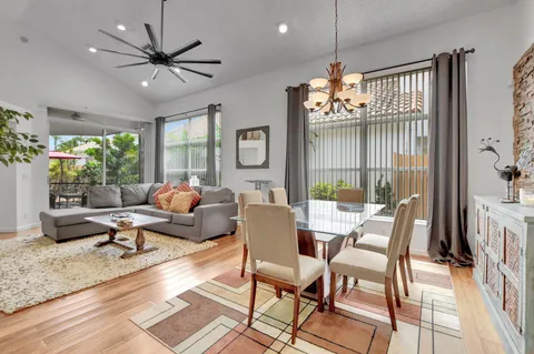 a living room with furniture chandelier and a large window