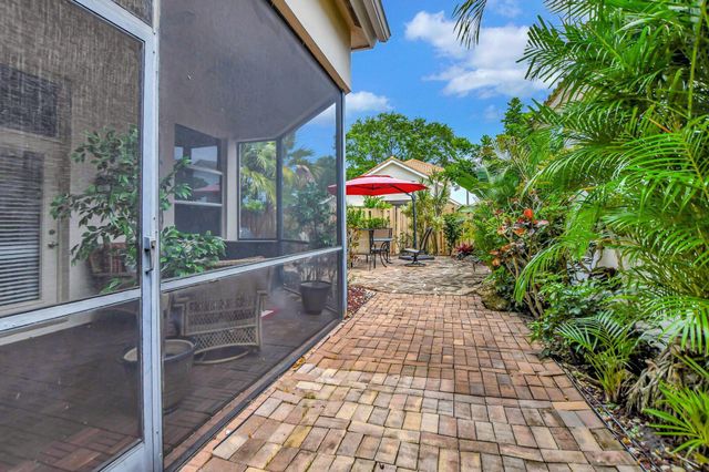 a view of a patio with a table and chairs under an umbrella