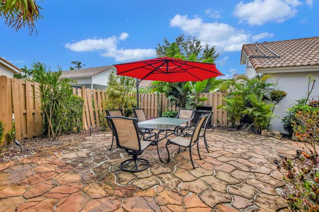 a view of a house with potted plants