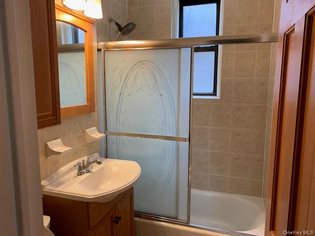 43-33 48th Street, Unit 4A Queens, NY 11104 - Photo 8 of 14 a bathroom with a sink and mirror