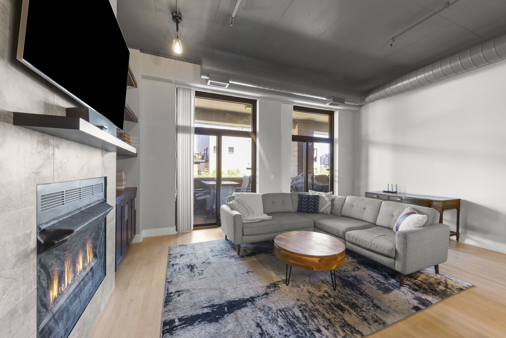 1301 West Madison Street, Unit 305 Chicago, IL 60607 - Photo 9 of 22 a living room with furniture and a fireplace