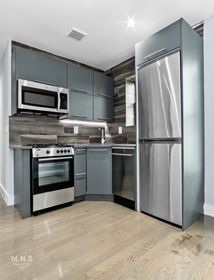 a kitchen with stainless steel appliances granite countertop a refrigerator stove and microwave