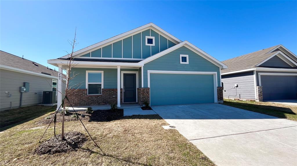 403 Ashbrook Way Princeton, TX 75407 - Photo 2 of 23 Contemporary single-story residence featuring a two-car garage, brick facade accents, and a covered front porch entry