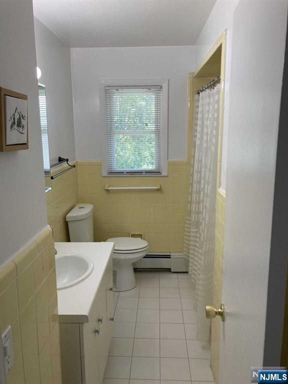 2430 6th Street, Unit 2 Fort Lee, NJ 07024 - Photo 15 of 15 a bathroom with a toilet sink and mirror