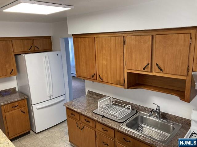 2430 6th Street, Unit 2 Fort Lee, NJ 07024 - Photo 9 of 15 a kitchen with stainless steel appliances a refrigerator and a stove