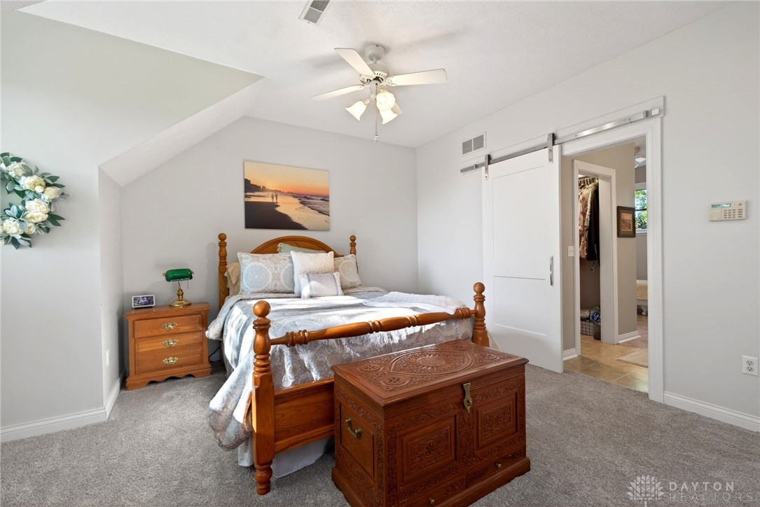 330 South Alpha Bellbrook Road Bellbrook, OH 45305 - Photo 35 of 87 This cozy bedroom features sloped ceilings and plush carpeting, with convenient access to an adjoining space.