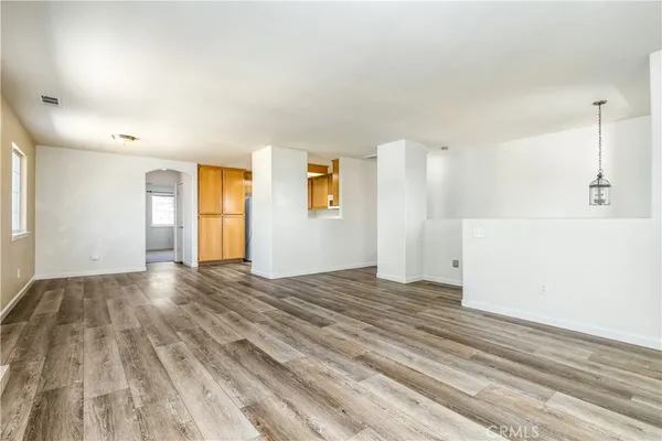 a view of a room with wooden floor and a window