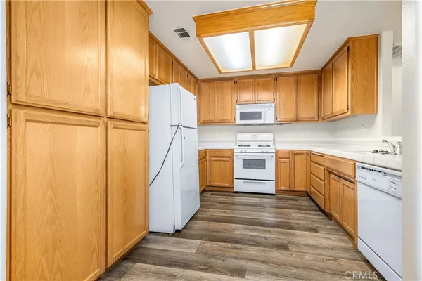 a kitchen with cabinets stainless steel appliances and a sink