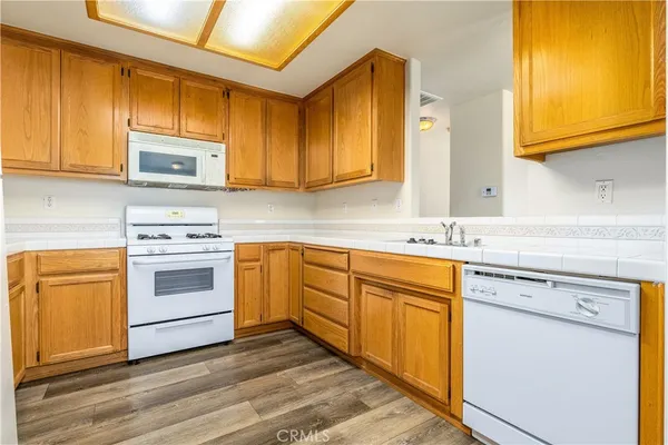 a kitchen with stainless steel appliances granite countertop cabinets and a microwave oven